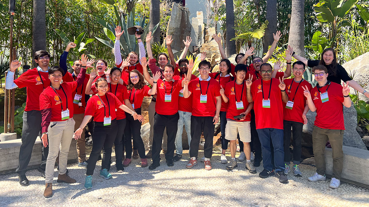 Smiling student volunteers welcome attendees